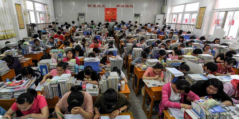 Packed classroom of children learning